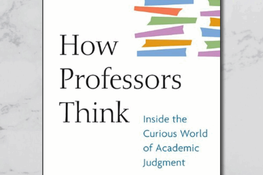 A screenshot of the front cover of the book that is being reviewed in this post. It is titled in the post, however it features a white background and colourful rectangular shapes that mimic a stack of books. The mid-section has been cropped for viewing on a blog post banner and grey marble is seen in the background to the sides.