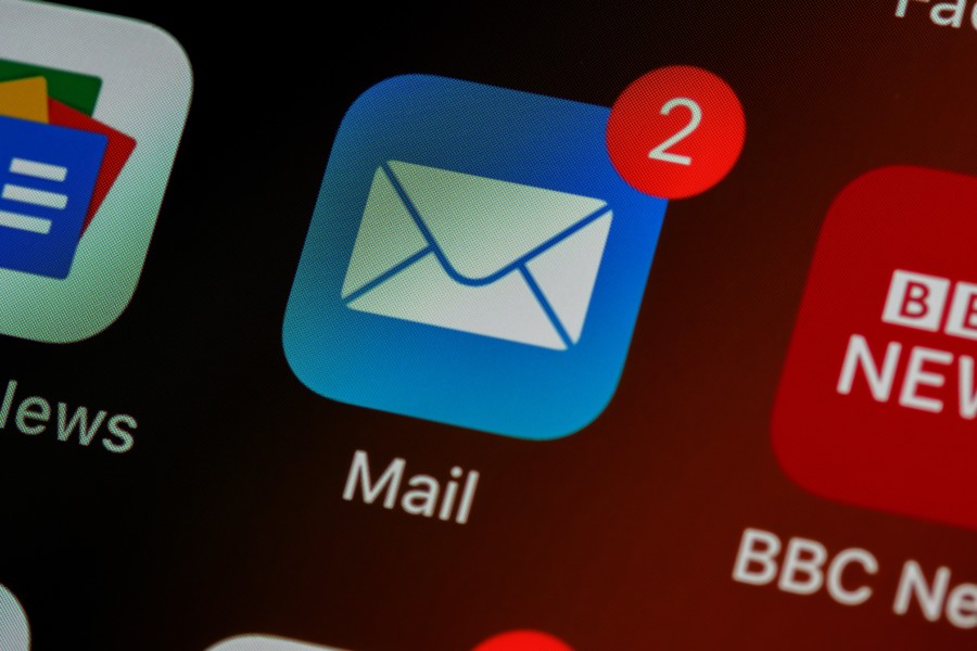 a blue phone screen app icon of apple mail with a white envelope symbol in the middle