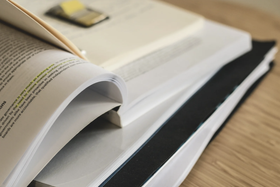 A photo of a stack of notebooks and papers.