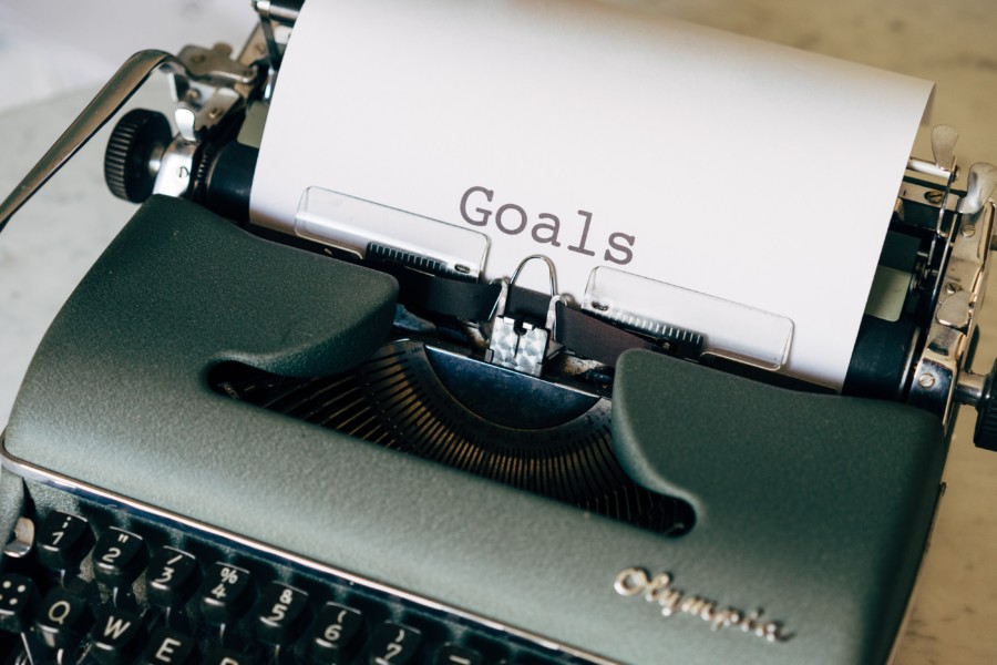 A typewriter with the word "Goals" typed cleanly in the centre of the paper in classic serif typewriter font.