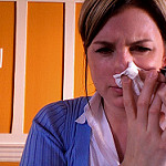 woman blowing her nose