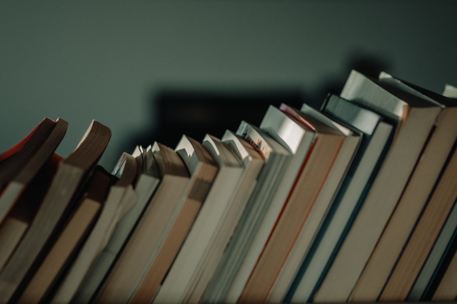 books stacked horizontally leaning on each other